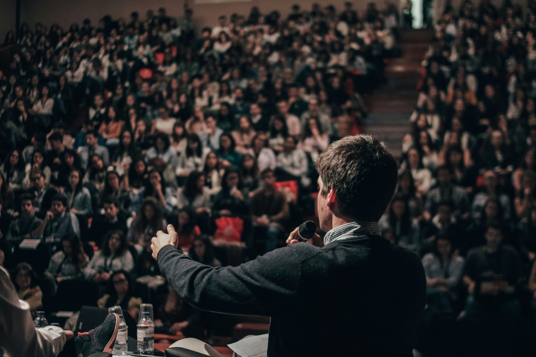 A young professional presenting ideas in an auditorium